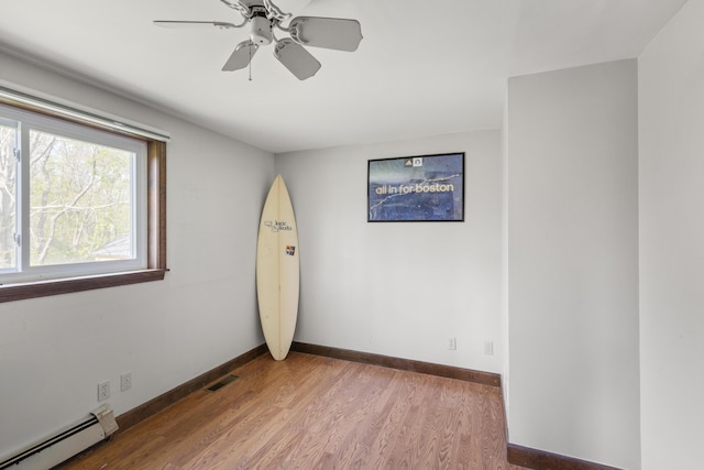 17 Westview Rd, Damariscotta, ME 04543 - unfurnished room featuring baseboard heating, baseboards, wood finished floors, and a ceiling fan