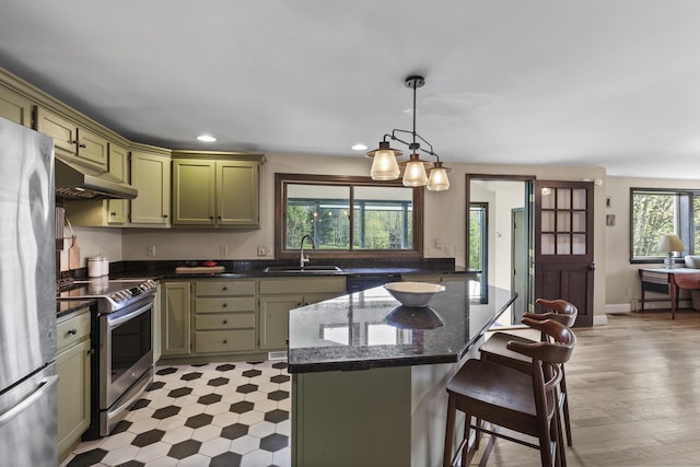 17 Westview Rd, Damariscotta, ME 04543 - kitchen with a sink, under cabinet range hood, stainless steel appliances, green cabinets, and a kitchen bar