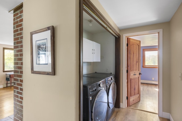 17 Westview Rd, Damariscotta, ME 04543 - laundry area with washer and clothes dryer, light wood-type flooring, cabinet space, and baseboard heating