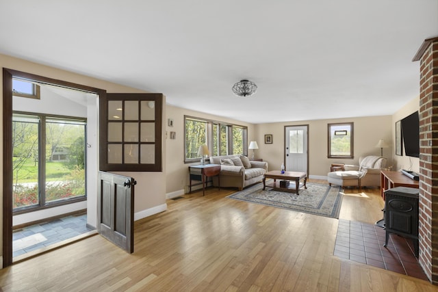 17 Westview Rd, Damariscotta, ME 04543 - living room with a wood stove, wood finished floors, plenty of natural light, and baseboards