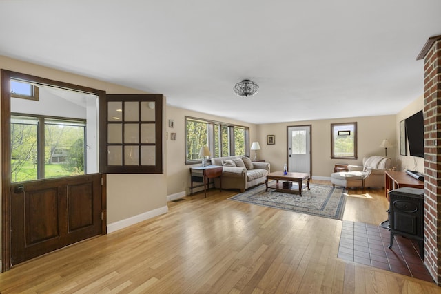 17 Westview Rd, Damariscotta, ME 04543 - living area featuring light wood-style flooring, baseboards, and a wood stove