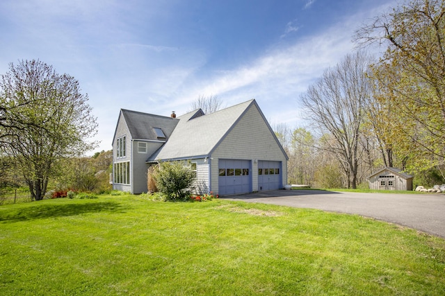 17 Westview Rd, Damariscotta, ME 04543 - view of side of property featuring a yard, a chimney, a garage, and a shingled roof