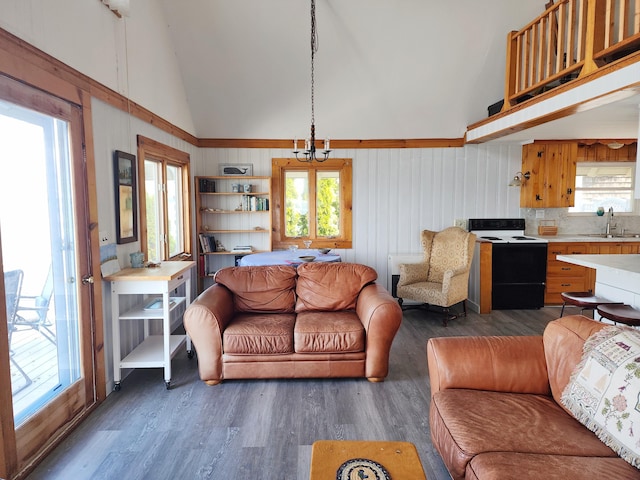 61 W Shore Rd, Harpswell, ME 04079 - living room featuring dark wood-style flooring, healthy amount of natural light, high vaulted ceiling, and a chandelier