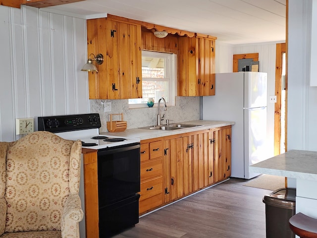 61 W Shore Rd, Harpswell, ME 04079 - kitchen featuring electric range, a sink, wood finished floors, light countertops, and freestanding refrigerator