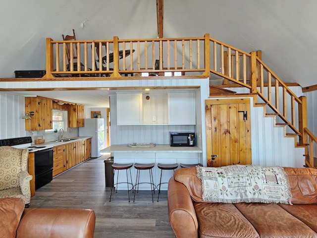 61 W Shore Rd, Harpswell, ME 04079 - living area featuring dark wood finished floors, stairs, and a high ceiling