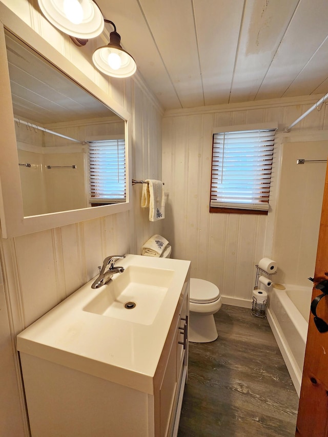 61 W Shore Rd, Harpswell, ME 04079 - bathroom with vanity, wood finished floors, toilet, washtub / shower combination, and baseboards