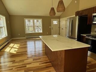 29 Sunnybrook Farm Rd, Bridgton, ME 04009 - kitchen with vaulted ceiling, appliances with stainless steel finishes, light wood-style flooring, a kitchen island, and decorative light fixtures