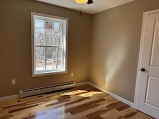 29 Sunnybrook Farm Rd, Bridgton, ME 04009 - unfurnished room with a baseboard heating unit, wood finished floors, and baseboards
