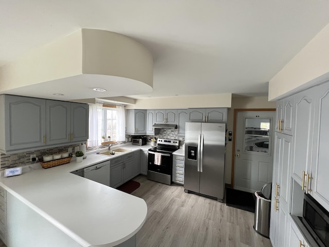 56 Solar Dr, Caribou, ME 04736 - kitchen featuring stainless steel appliances, gray cabinets, a peninsula, and backsplash
