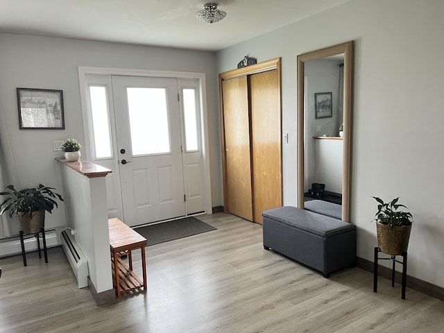 56 Solar Dr, Caribou, ME 04736 - foyer entrance featuring light wood-style flooring, a baseboard radiator, and baseboards
