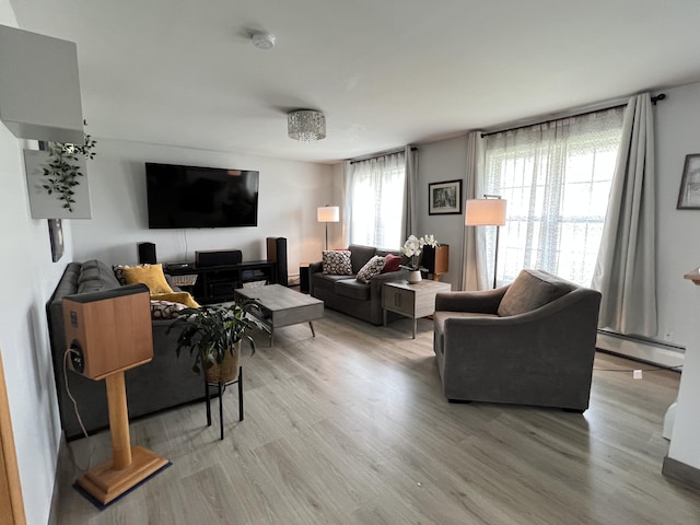 56 Solar Dr, Caribou, ME 04736 - living room featuring a baseboard heating unit and light wood finished floors