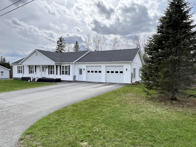 56 Solar Dr, Caribou, ME 04736 - ranch-style house featuring driveway, an attached garage, a porch, a front yard, and a shingled roof