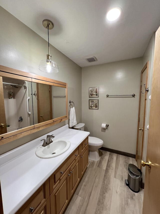56 Solar Dr, Caribou, ME 04736 - full bathroom with wood finished floors, vanity, toilet, and a shower