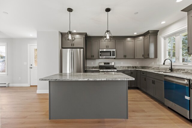 32 Jackson St, Portland, ME 04103 - kitchen featuring stainless steel appliances, a sink, gray cabinets, a center island, and recessed lighting