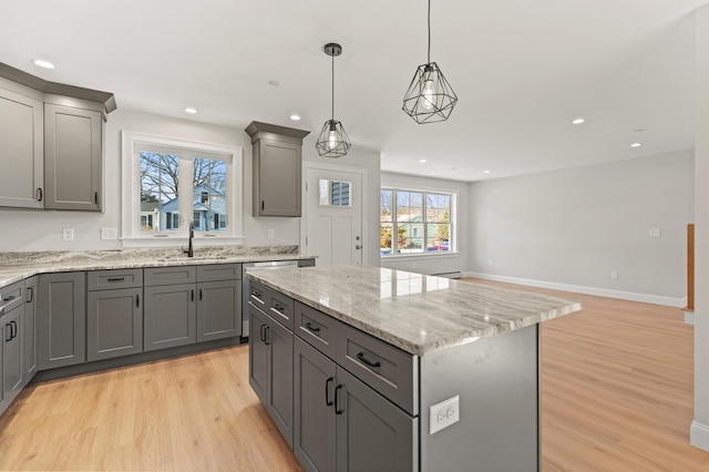 32 Jackson St, Portland, ME 04103 - kitchen featuring gray cabinetry, a sink, light wood-style flooring, a center island, and recessed lighting