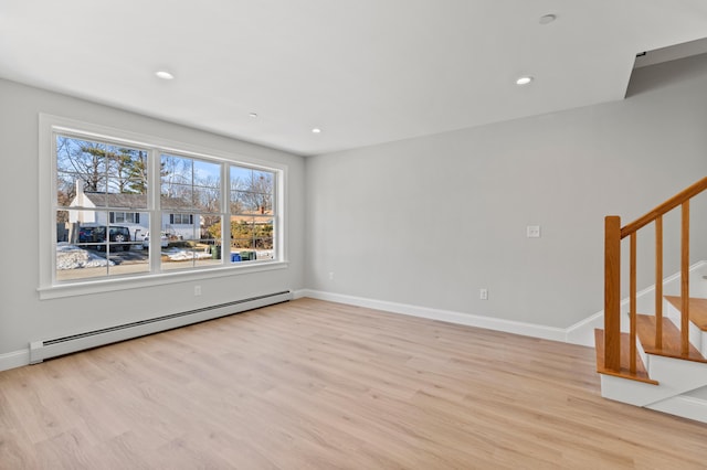 32 Jackson St, Portland, ME 04103 - unfurnished living room featuring a baseboard heating unit, light wood-style flooring, stairs, recessed lighting, and baseboards