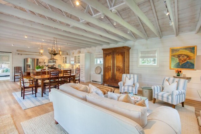 32 Murray Hill Rd, Boothbay, ME 04544 - living area with light wood finished floors, rail lighting, beamed ceiling, wooden ceiling, and wood walls
