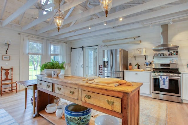 32 Murray Hill Rd, Boothbay, ME 04544 - kitchen featuring stainless steel appliances, wall chimney range hood, light wood-style flooring, white cabinets, and light countertops