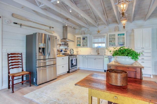 32 Murray Hill Rd, Boothbay, ME 04544 - kitchen with appliances with stainless steel finishes, wall chimney range hood, a sink, beamed ceiling, and light wood-type flooring