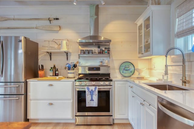 32 Murray Hill Rd, Boothbay, ME 04544 - kitchen with appliances with stainless steel finishes, wall chimney exhaust hood, a sink, white cabinets, and light countertops