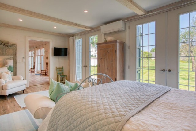 32 Murray Hill Rd, Boothbay, ME 04544 - bedroom featuring french doors, a wall unit AC, beamed ceiling, access to outside, and wood finished floors