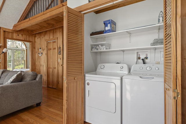 33 Bernier Ln, Harpswell, ME 04079 - washroom with washing machine and dryer, light wood finished floors, and wood walls