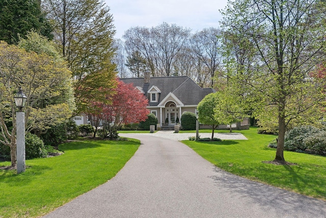 11 Clubhouse Dr, Kennebunk, ME 04043 - view of front of home featuring curved driveway, a front yard, and a chimney