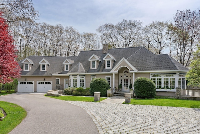 11 Clubhouse Dr, Kennebunk, ME 04043 - view of front of home featuring driveway, a chimney, and roof with shingles