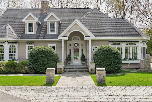 11 Clubhouse Dr, Kennebunk, ME 04043 - view of front of home with a chimney, a shingled roof, and a front yard