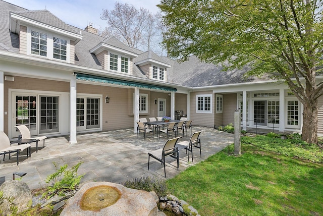 11 Clubhouse Dr, Kennebunk, ME 04043 - back of property featuring a patio area, a lawn, and a shingled roof
