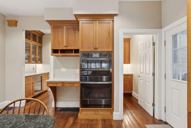 11 Clubhouse Dr, Kennebunk, ME 04043 - kitchen featuring beverage cooler, dark wood-style flooring, glass insert cabinets, and brown cabinets