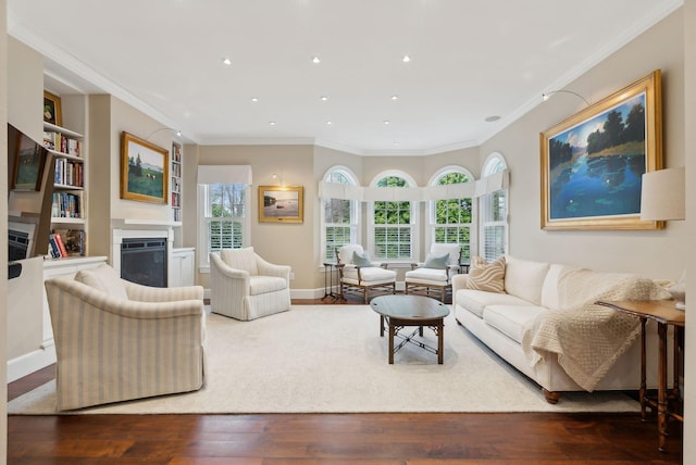 11 Clubhouse Dr, Kennebunk, ME 04043 - living area with a fireplace, ornamental molding, built in features, wood finished floors, and recessed lighting