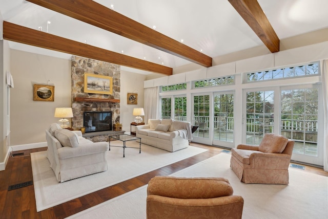 11 Clubhouse Dr, Kennebunk, ME 04043 - living area featuring beam ceiling, plenty of natural light, wood finished floors, baseboards, and a fireplace