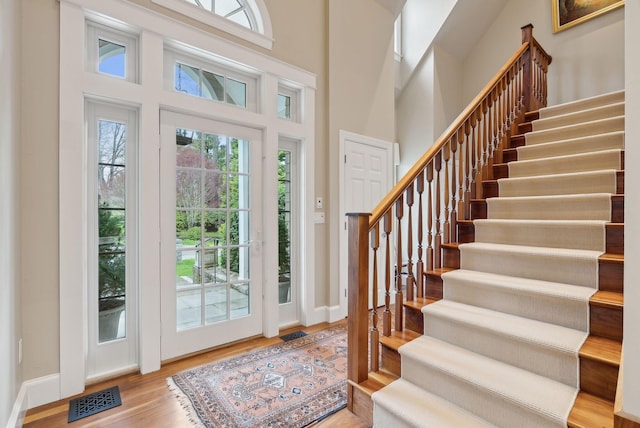 11 Clubhouse Dr, Kennebunk, ME 04043 - foyer entrance with stairway, wood finished floors, baseboards, and a towering ceiling