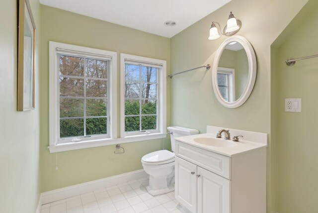 11 Clubhouse Dr, Kennebunk, ME 04043 - bathroom with baseboards, toilet, vanity, and tile patterned floors