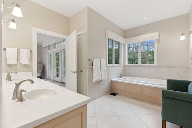 11 Clubhouse Dr, Kennebunk, ME 04043 - bathroom with tile walls, tile patterned flooring, a bath, double vanity, and wainscoting