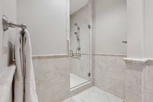 11 Clubhouse Dr, Kennebunk, ME 04043 - bathroom with a stall shower, tile walls, and wainscoting
