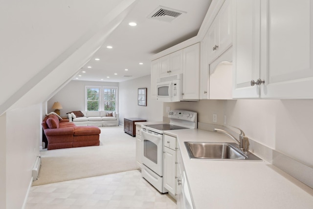 11 Clubhouse Dr, Kennebunk, ME 04043 - kitchen with white appliances, a sink, recessed lighting, a baseboard radiator, and white cabinets