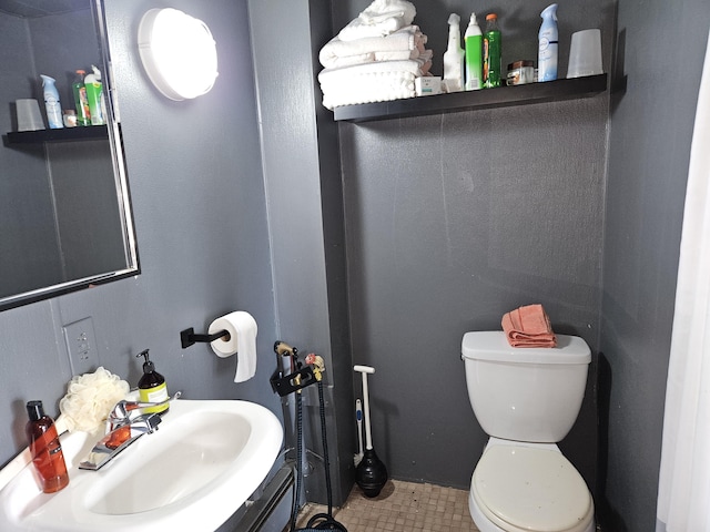 58 Cedar St, Bangor, ME 04401 - half bathroom with toilet, vanity, and tile patterned floors