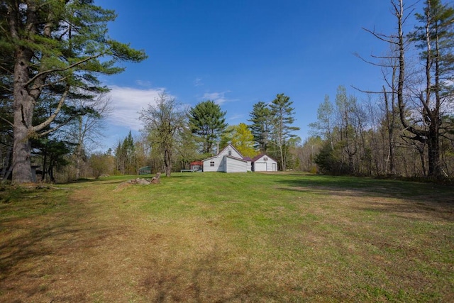 283 School St, Weld, ME 04285 - view of grassy yard featuring a detached garage and an outdoor structure