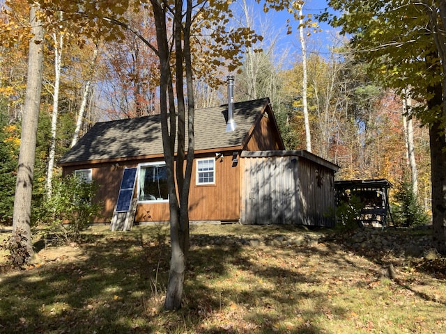 509 Blackberry Ln, Rumford, ME 04276 - view of side of home featuring a shingled roof and a yard