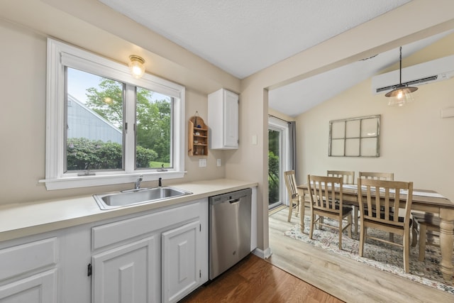 4 Oakview Dr Unit 4, Cape Elizabeth, ME 04107 - kitchen with dishwasher, a wall unit AC, vaulted ceiling, dark wood-style floors, and light countertops