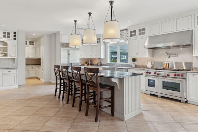 10 Jameson Dr, Falmouth, ME 04105 - kitchen with range hood, premium appliances, backsplash, light tile patterned floors, and white cabinets
