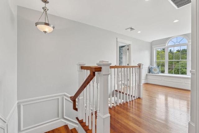 10 Jameson Dr, Falmouth, ME 04105 - staircase with wood finished floors, a decorative wall, wainscoting, and recessed lighting
