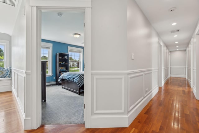 10 Jameson Dr, Falmouth, ME 04105 - hall with a decorative wall, wood finished floors, a wainscoted wall, and baseboard heating