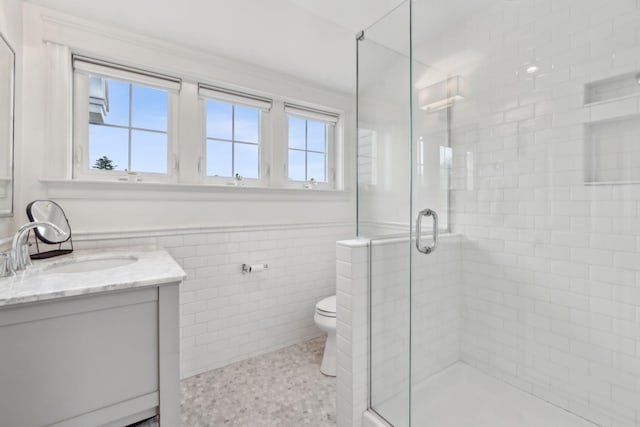 10 Jameson Dr, Falmouth, ME 04105 - bathroom with vanity, tile walls, a shower stall, a wainscoted wall, and toilet