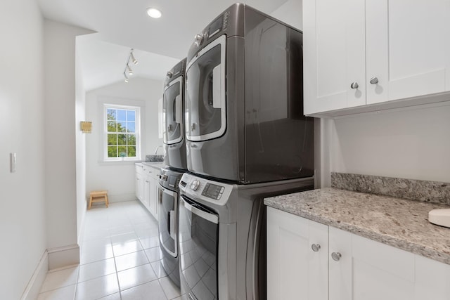 10 Jameson Dr, Falmouth, ME 04105 - laundry room with stacked washing machine and dryer, cabinet space, baseboards, light tile patterned floors, and recessed lighting