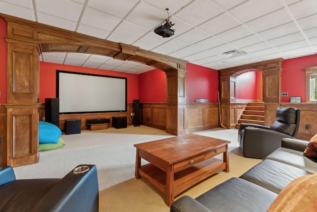 10 Jameson Dr, Falmouth, ME 04105 - home theater featuring ornate columns, arched walkways, a paneled ceiling, wainscoting, and light carpet