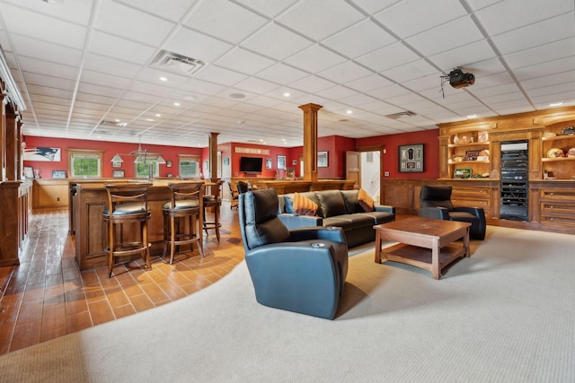 10 Jameson Dr, Falmouth, ME 04105 - living area with a bar, ornate columns, a drop ceiling, and carpet flooring