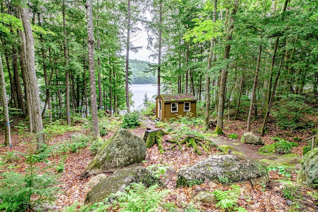 134 Valhalla Ln, Norway, ME 04268 - view of yard with a forest view and a water view